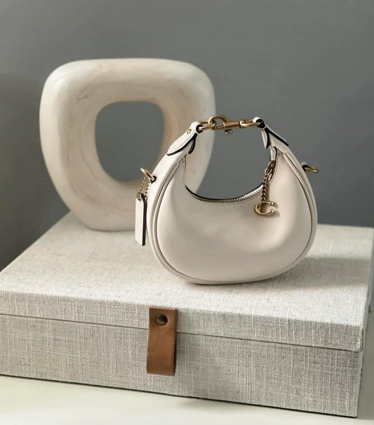 Chic Demi-Lune Mini Shoulder Bag with Gold-Tone Chain and Charm Accent